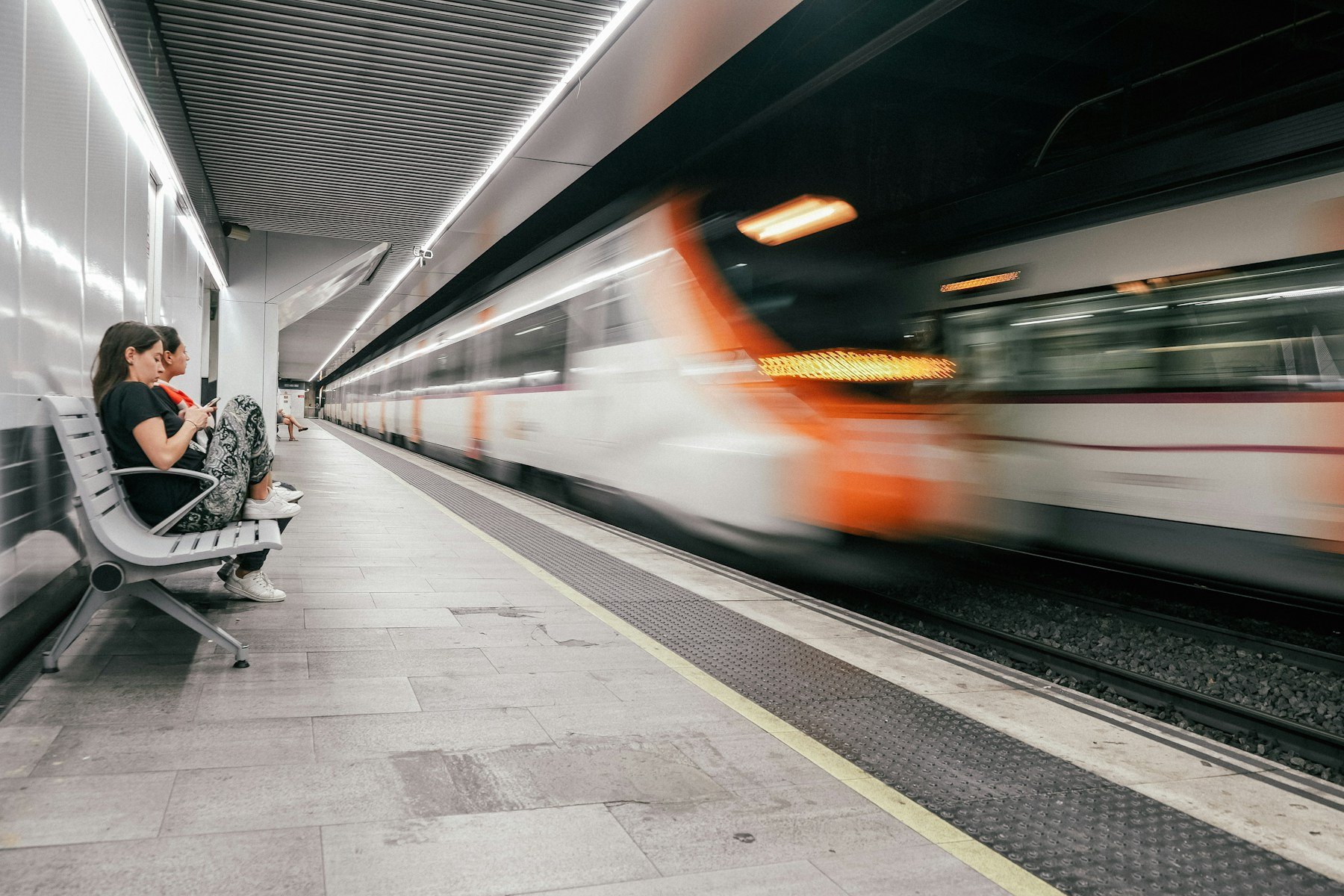 Barcelona Metro train arriving at an underground platform
