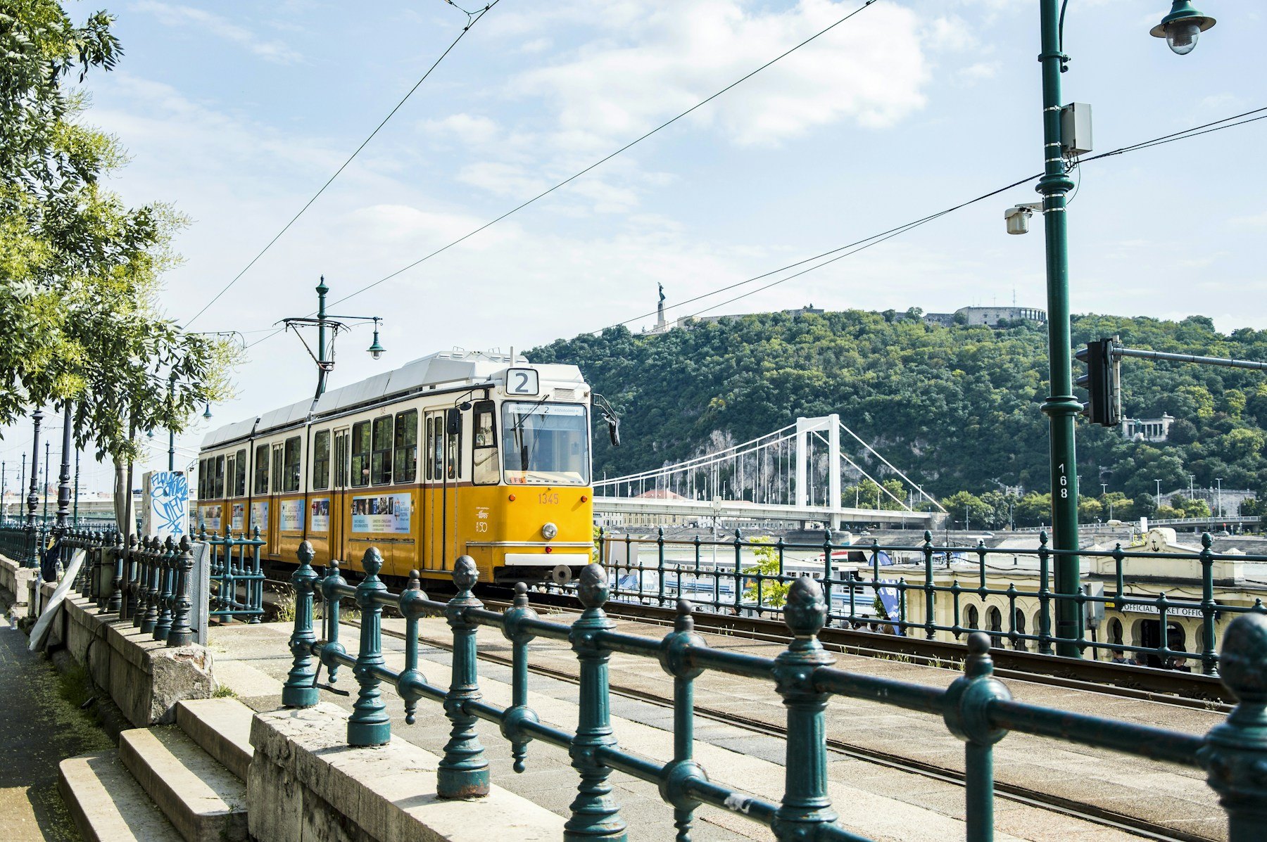 Yellow tram travelling through central Budapest