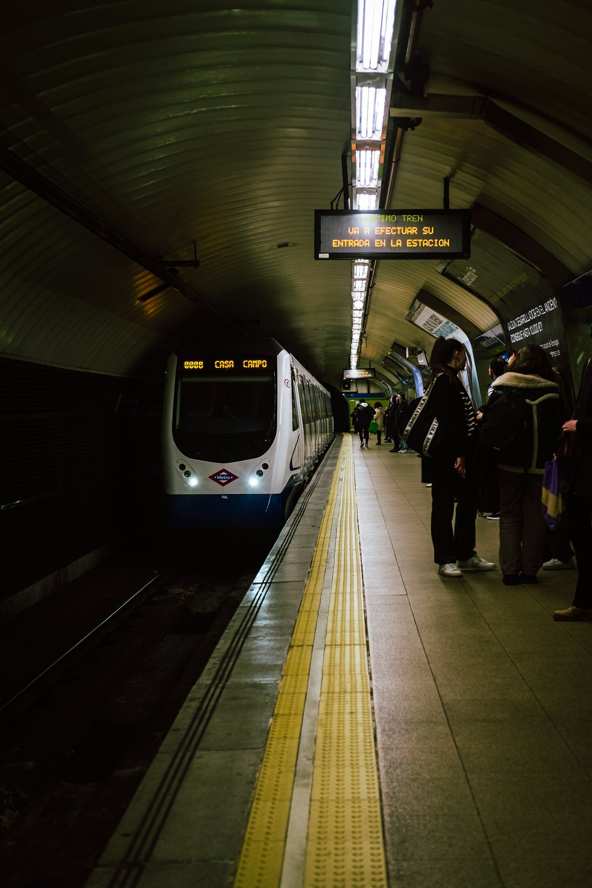 Madrid Metro train arriving at an underground platform