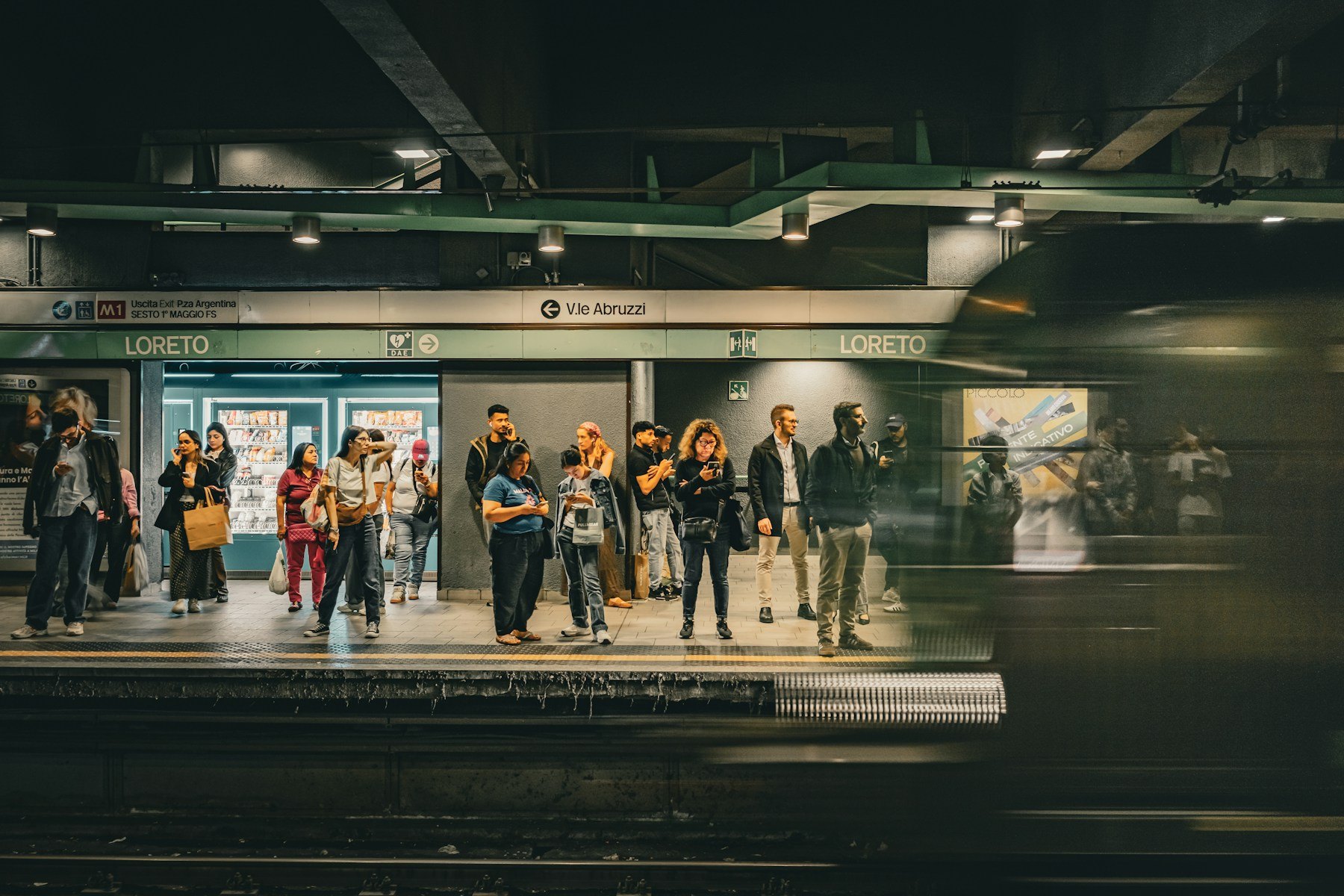 Passengers waiting as a Milan Metro train arrives