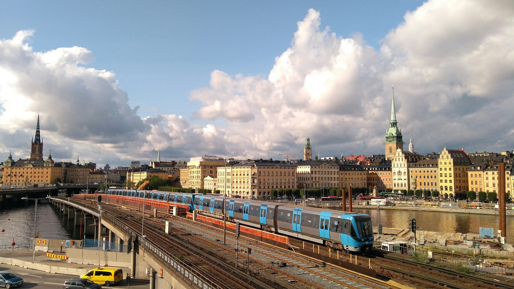 Stockholm commuter train travelling past city buildings