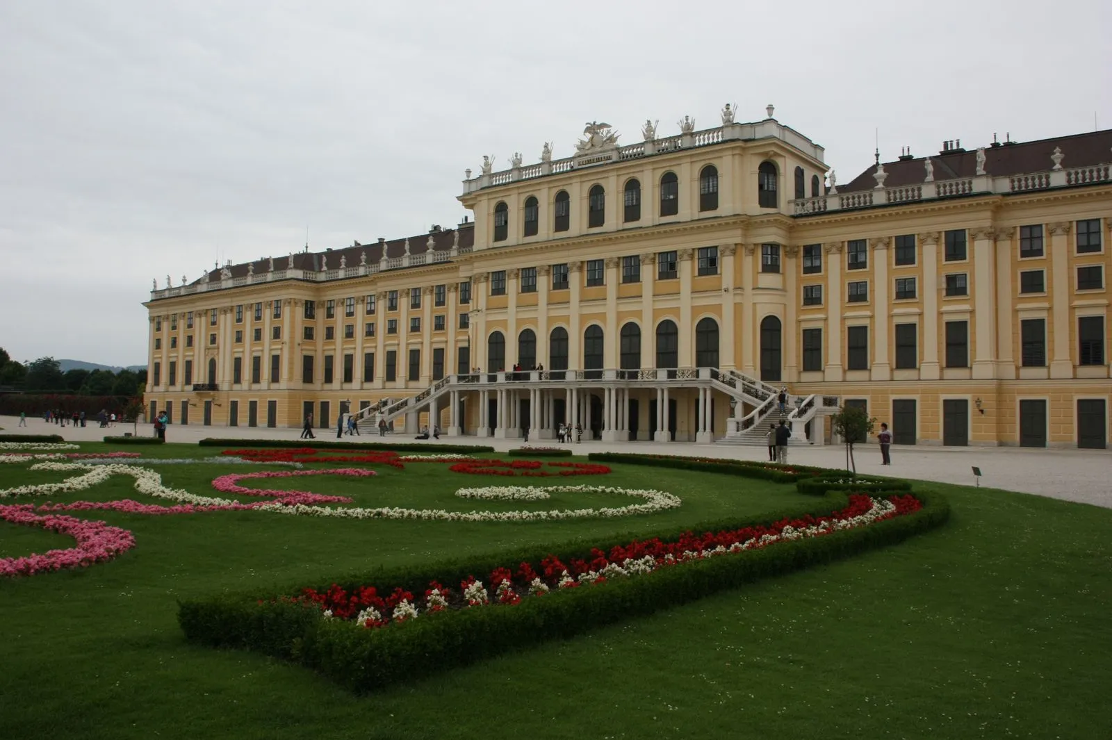Schönbrunn Palace in Vienna behind curved flower beds and lawn