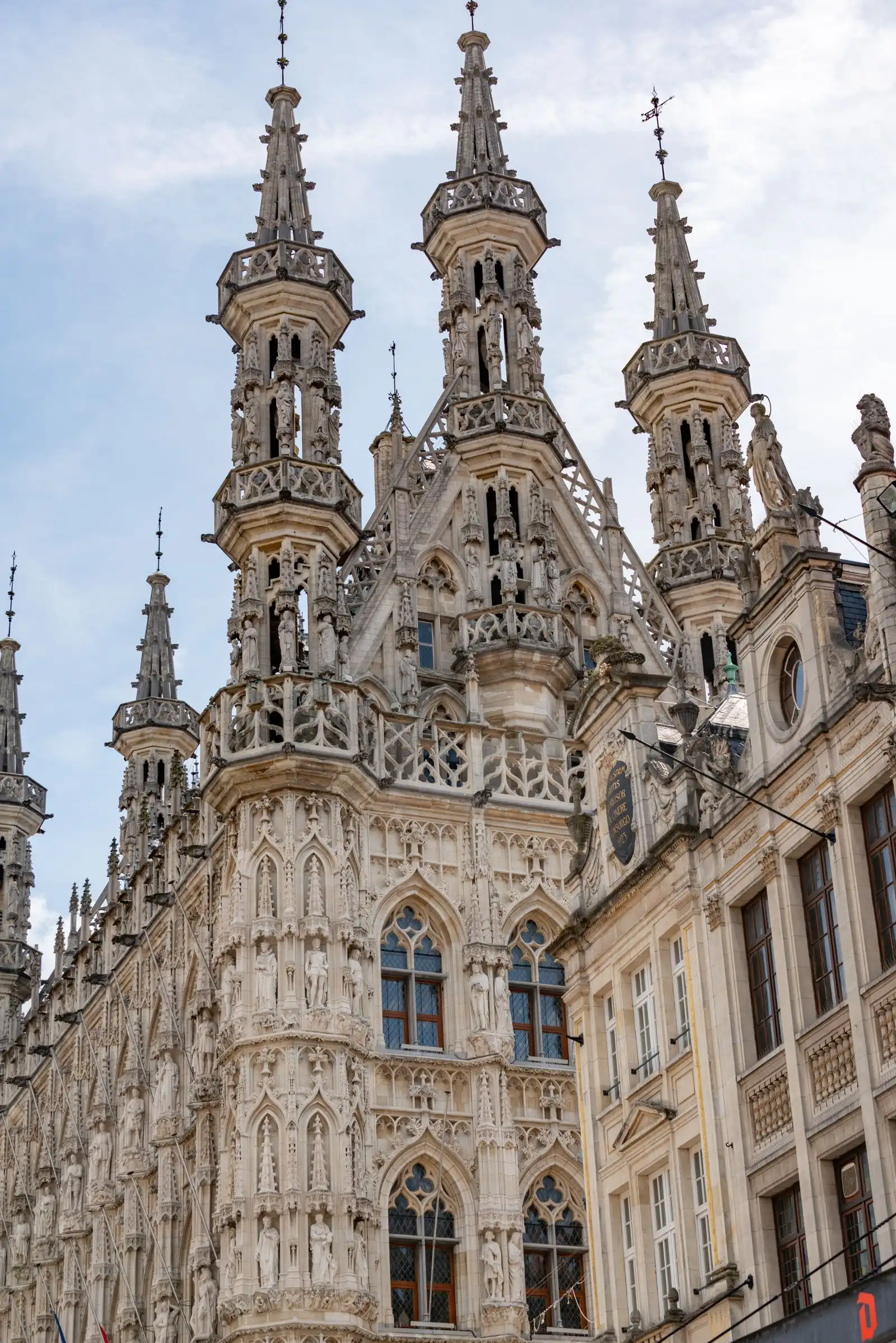 Carved stonework and spires on Leuven's town hall