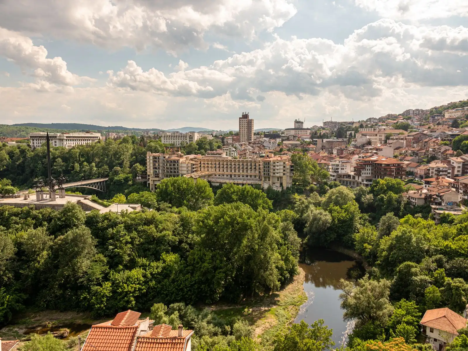 Veliko Tarnovo's buildings across wooded hillsides