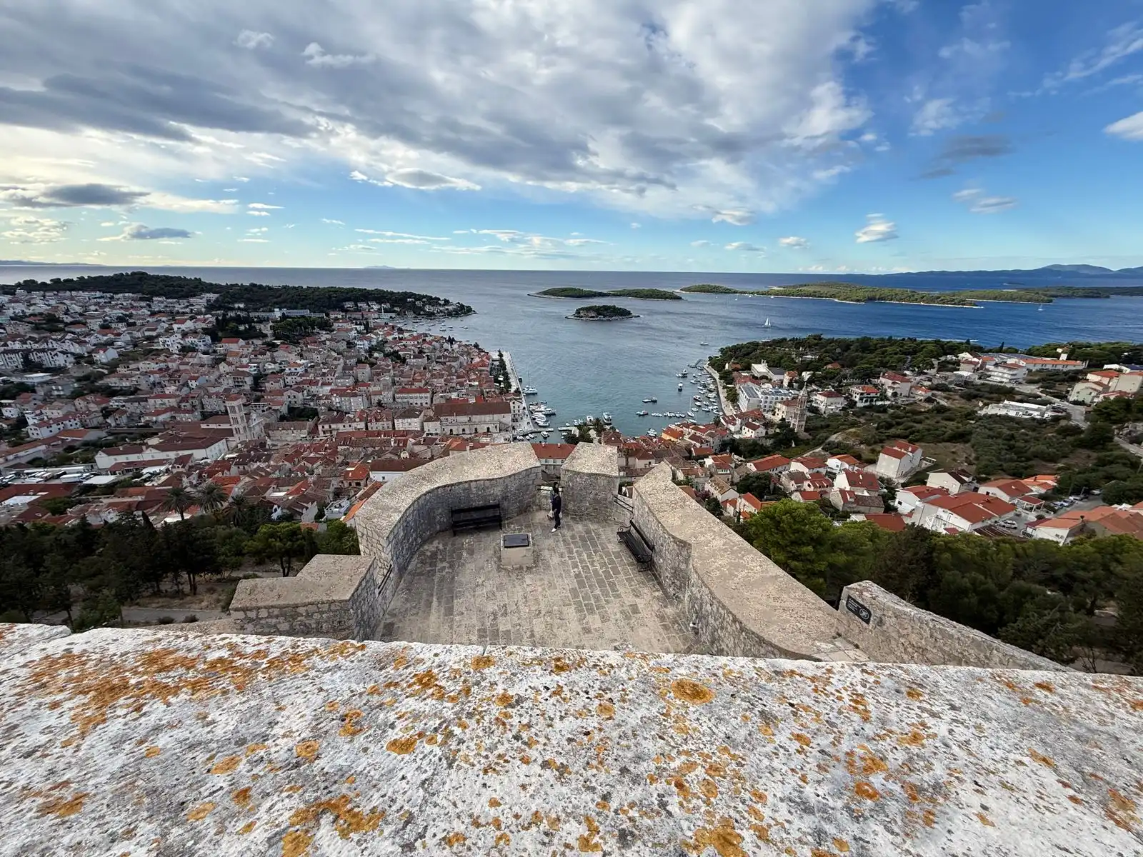 Hvar's red-roofed buildings and harbour below the fortress walls