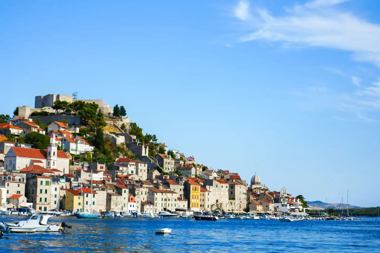 Šibenik's waterfront buildings below a hilltop fortress