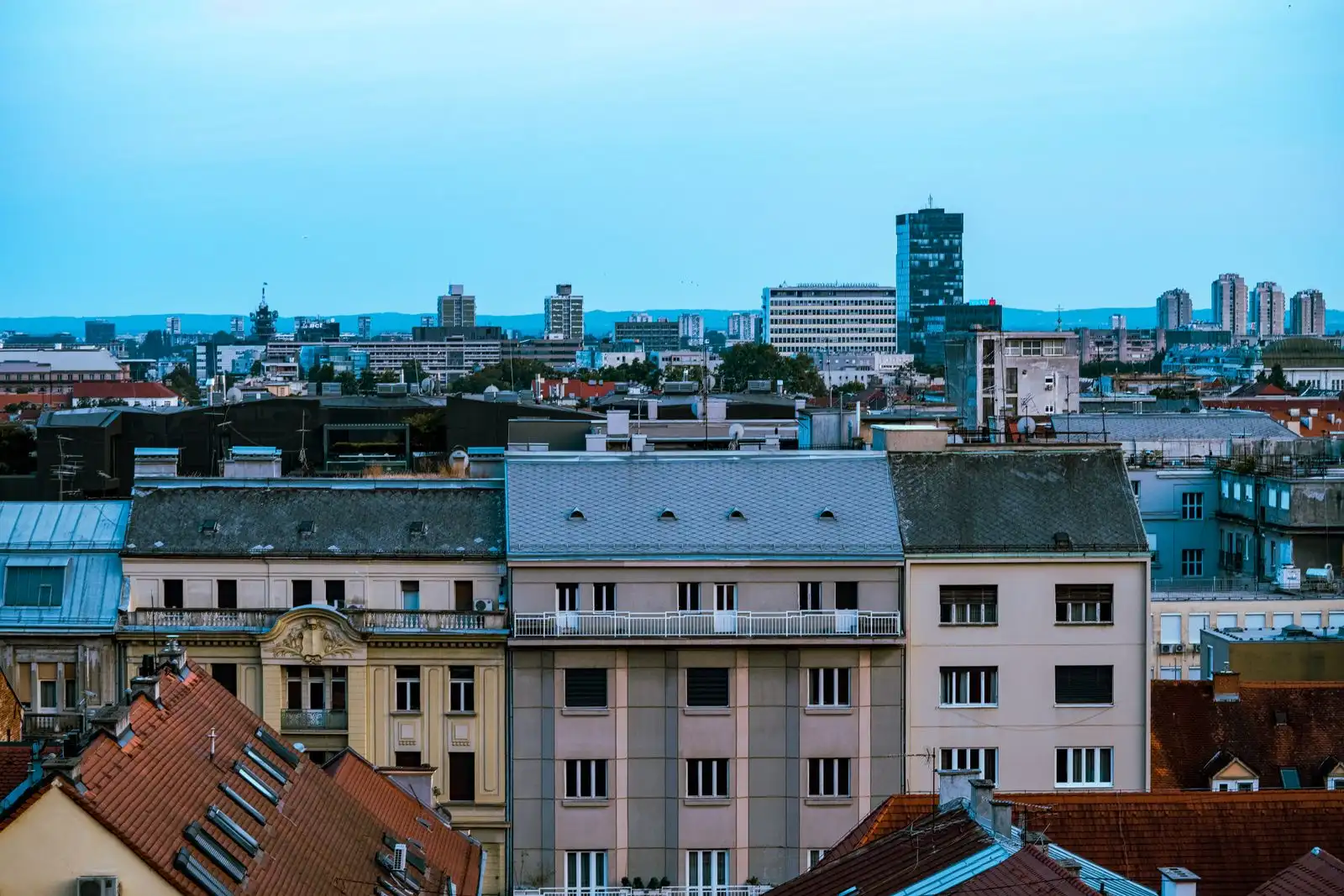Zagreb's rooftops and modern skyline under a blue sky