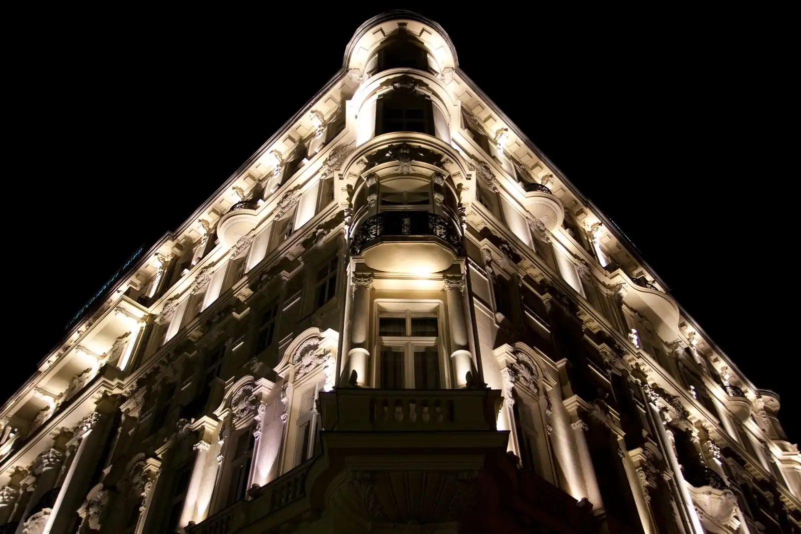 An illuminated historic building in Karlovy Vary at night