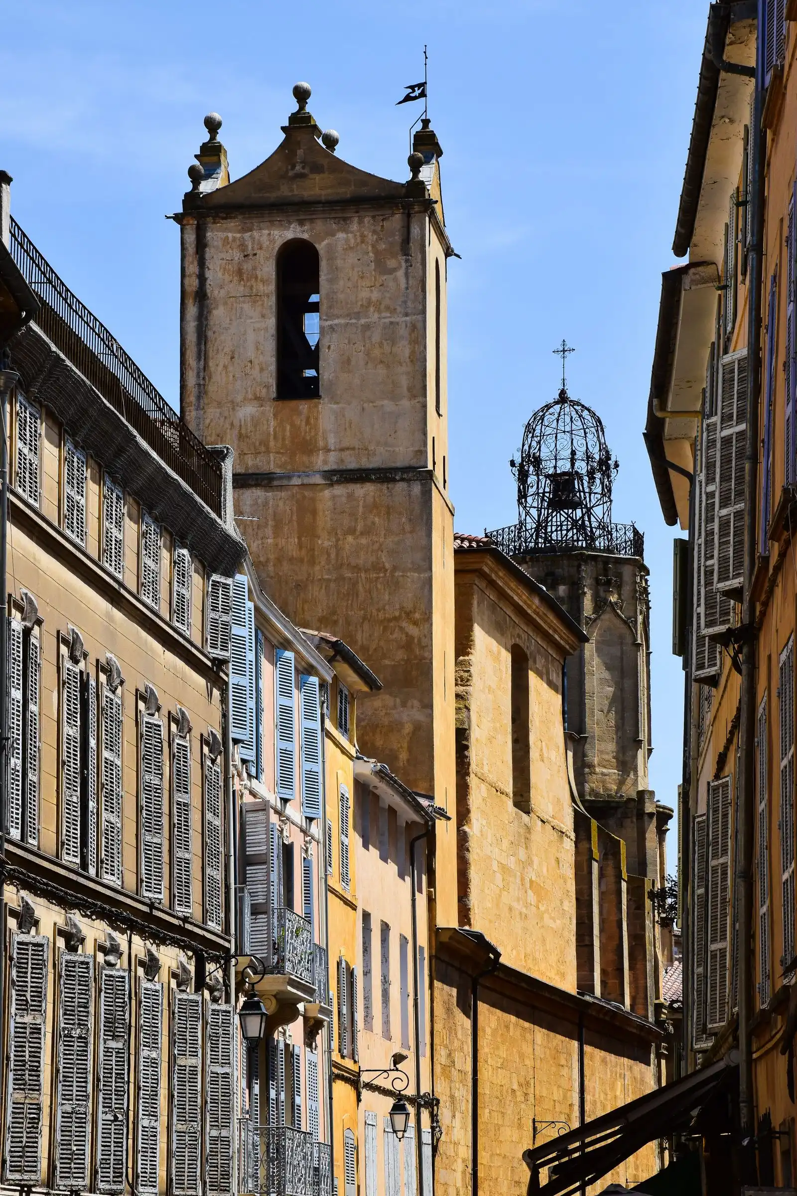 Shuttered facades and a church tower in Aix-en-Provence