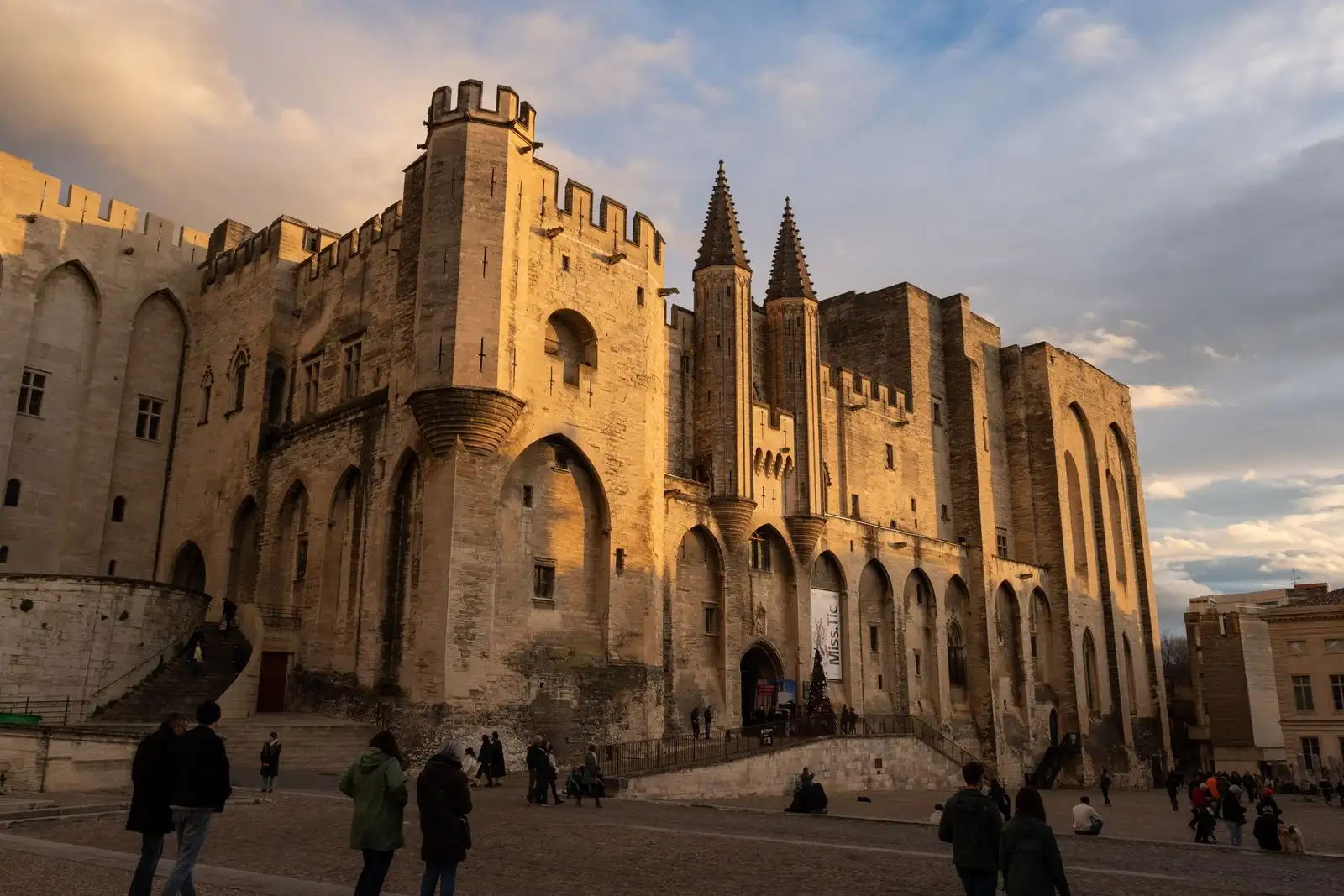 The stone walls and towers of the Palais des Papes in Avignon