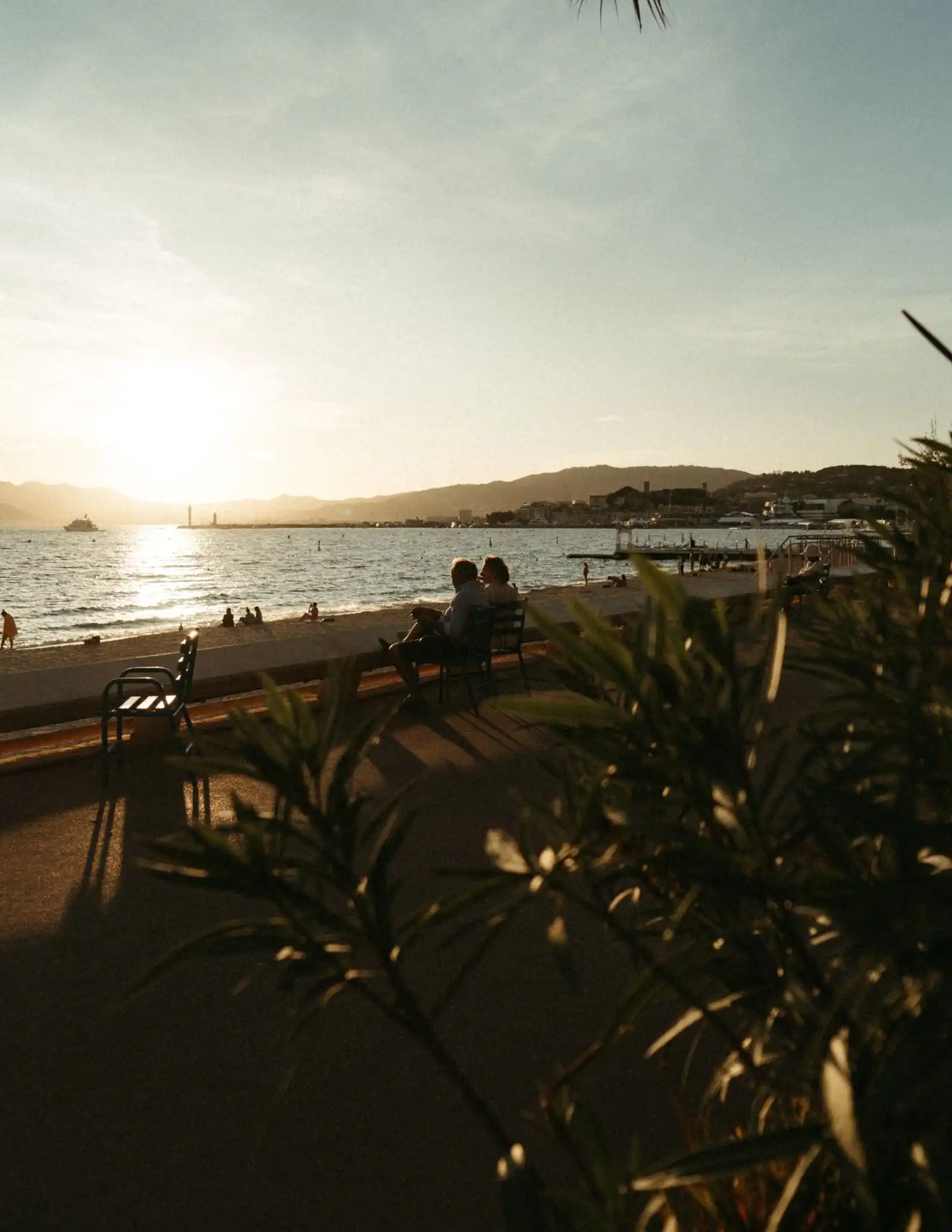 People beside the beach in Cannes in the evening