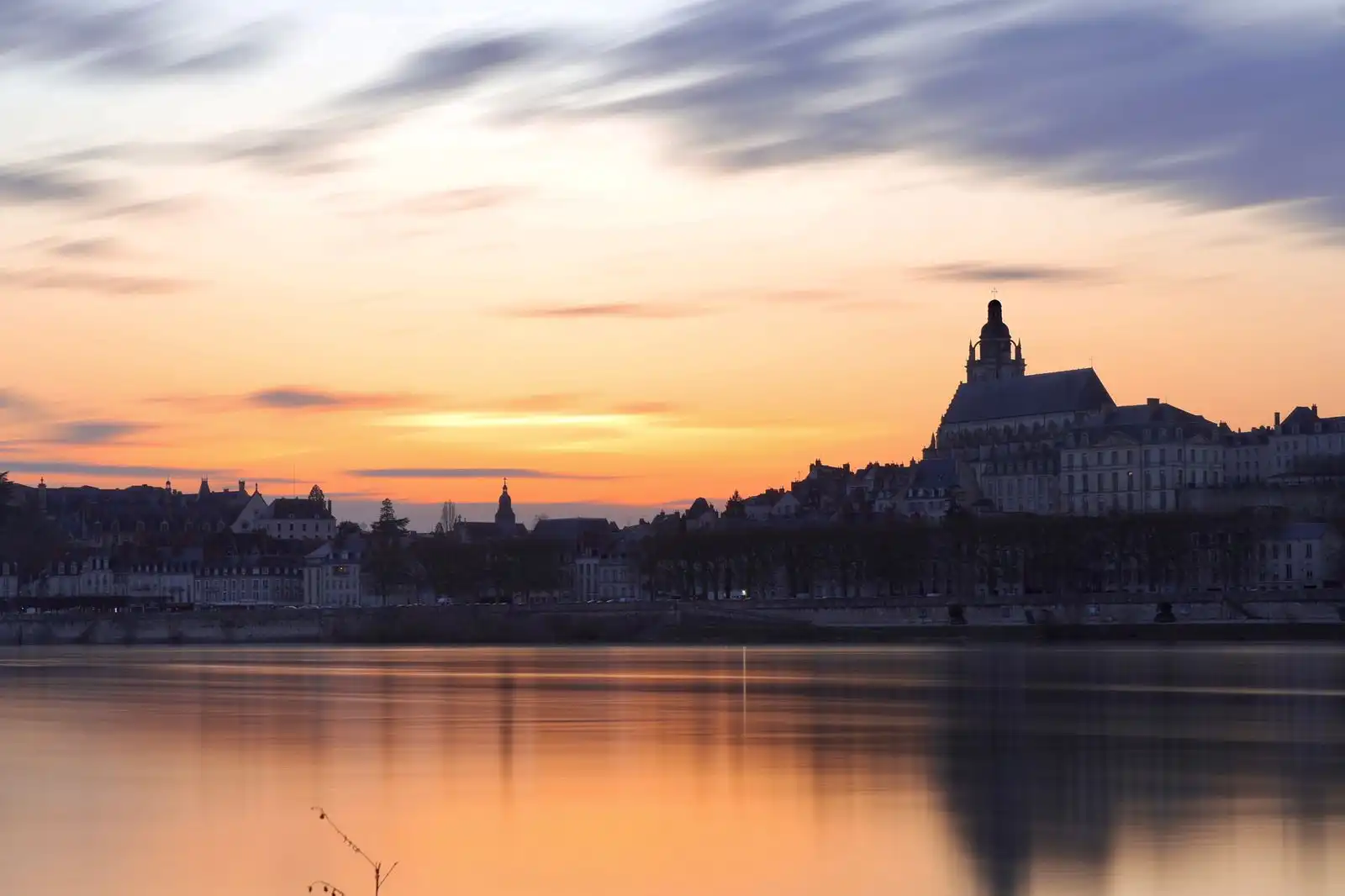 Blois and its reflection in the Loire River at sunset