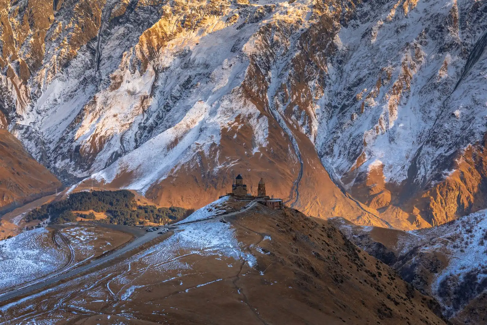Gergeti Trinity Church below snow-covered mountains near Stepantsminda