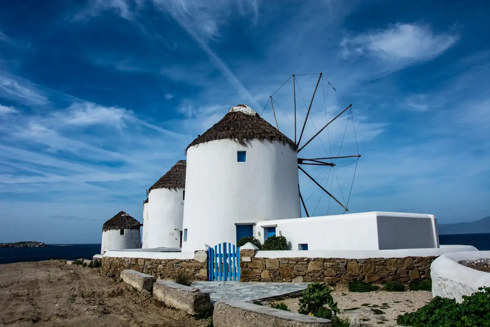 White windmills with thatched roofs on Mykonos