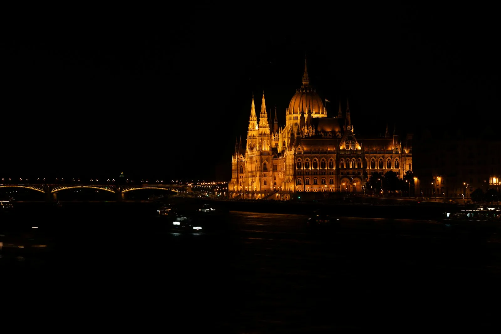 The illuminated Hungarian Parliament beside the Danube at night in Budapest