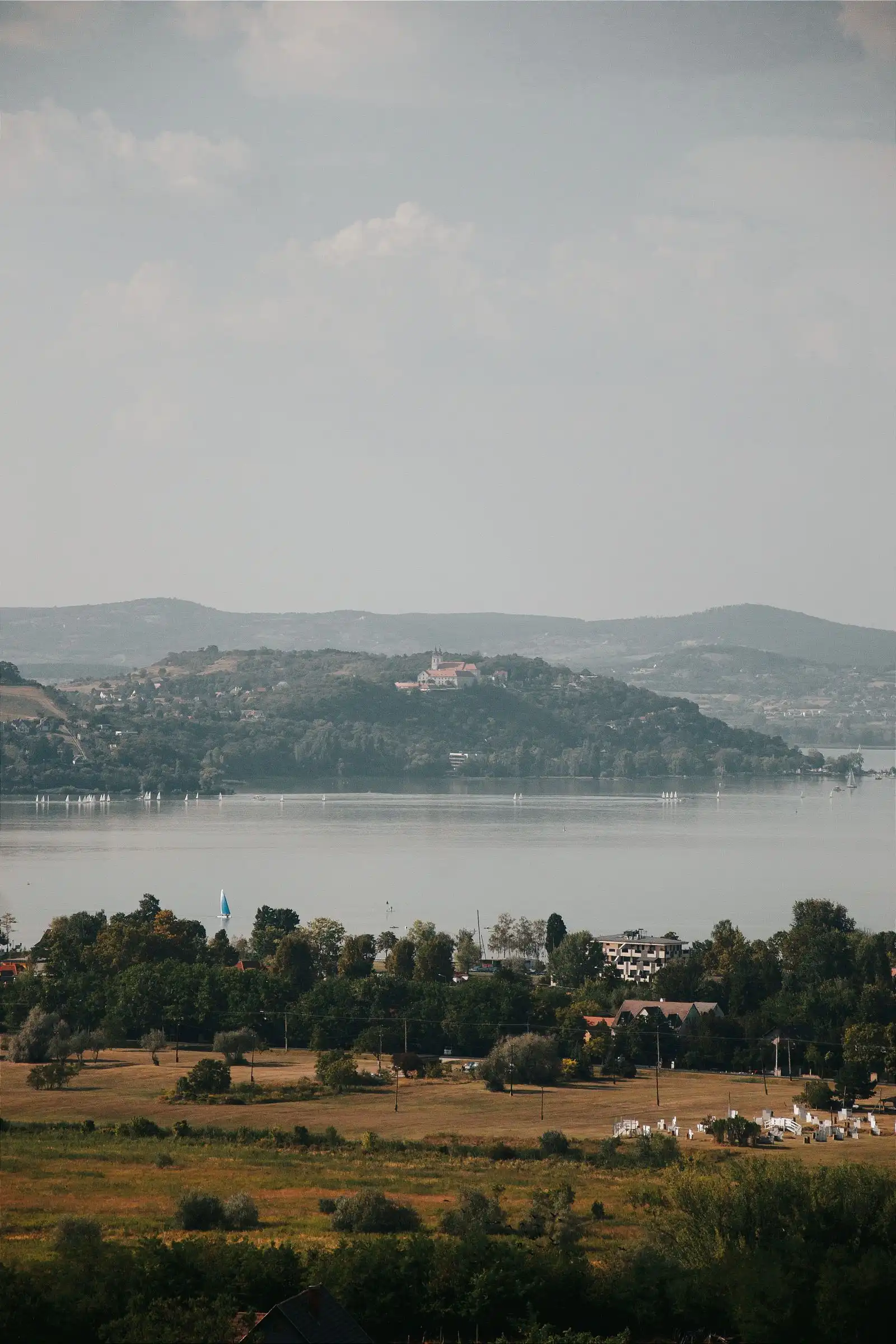 Lake Balaton with low hills and buildings on the far shore