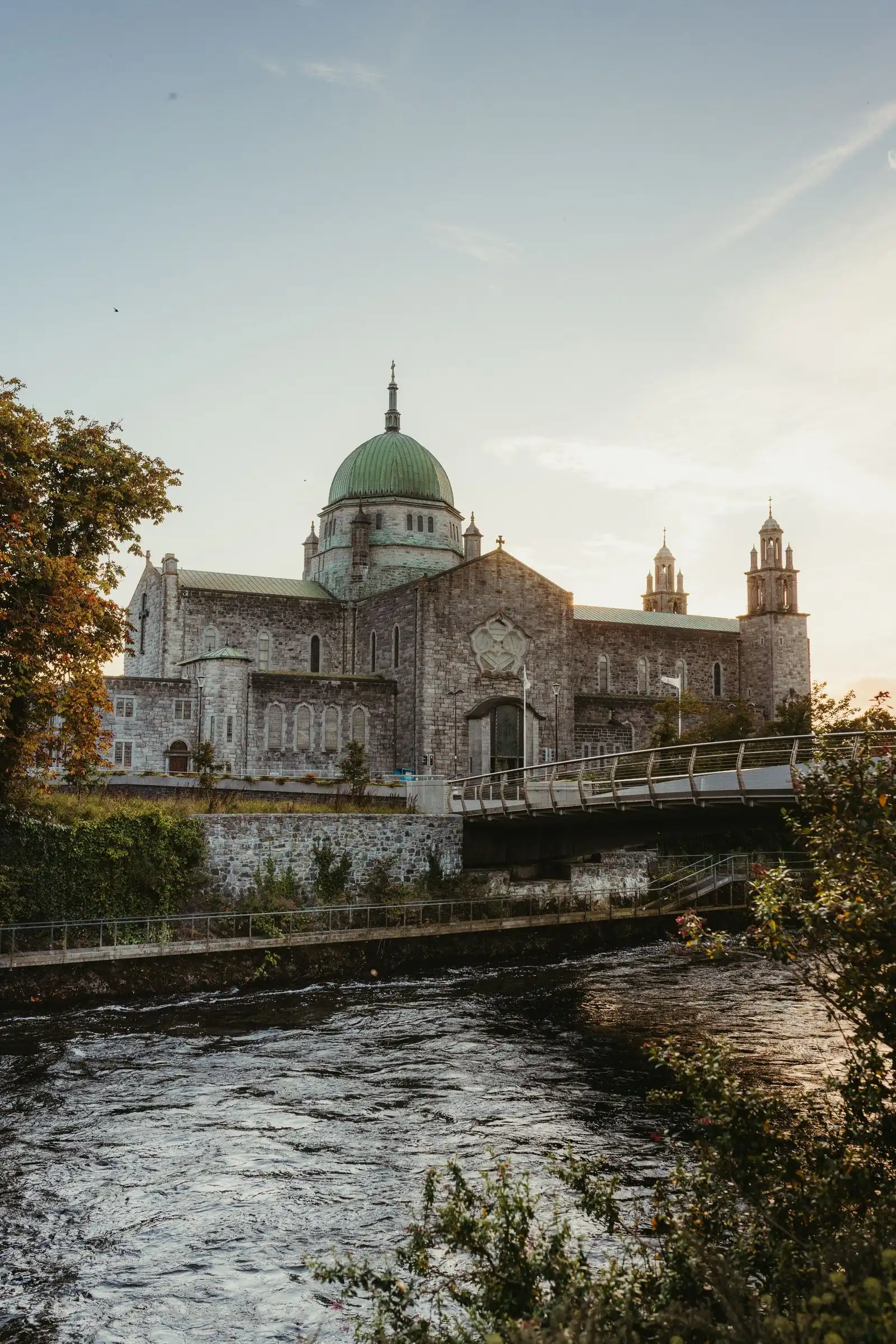 Galway Cathedral beside the river and a footbridge