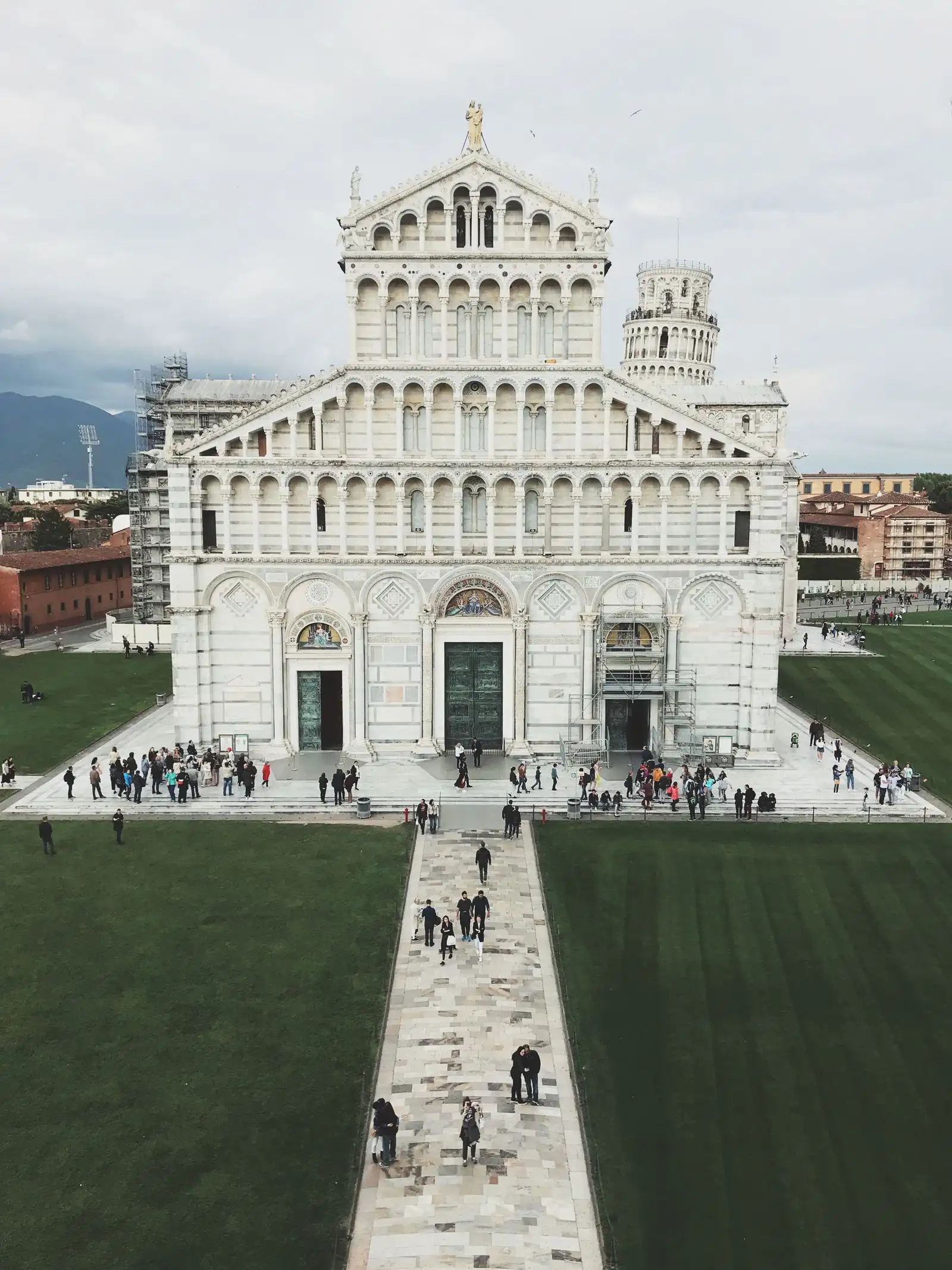 Pisa Cathedral and the Leaning Tower beneath a cloudy sky
