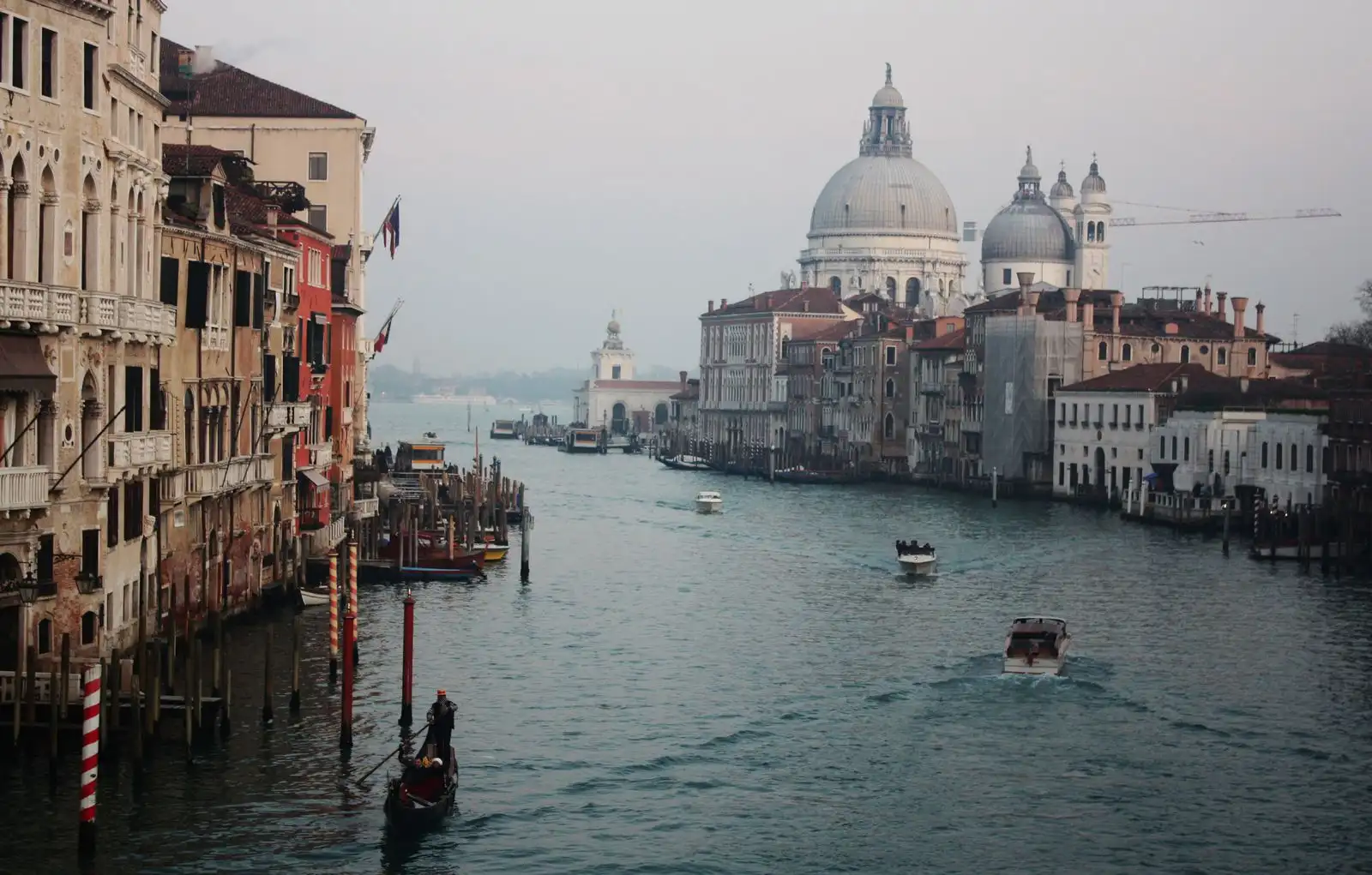 Boats on Venice's Grand Canal beside historic waterfront buildings