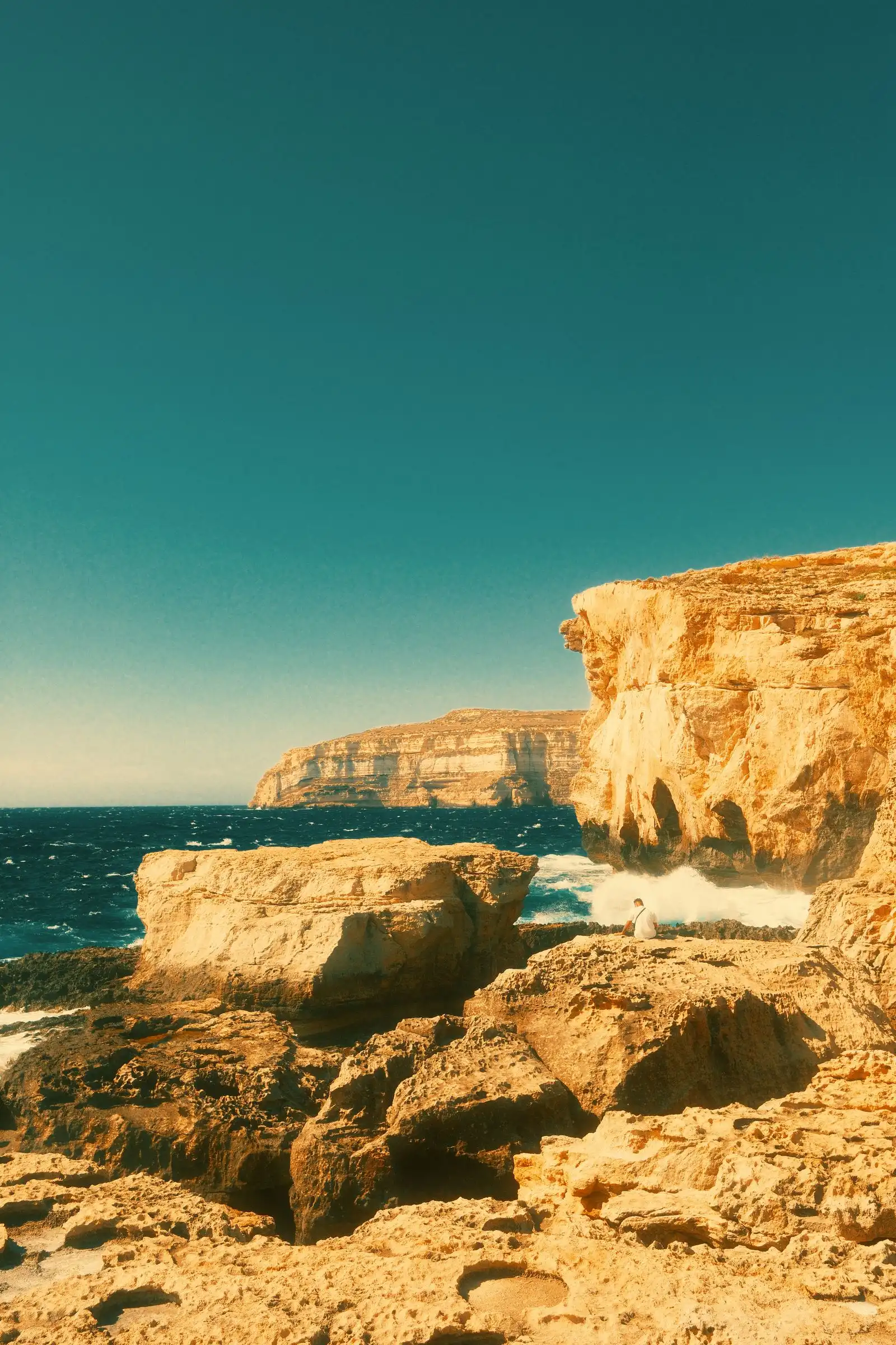 Waves below the rocky coastal cliffs of Gozo