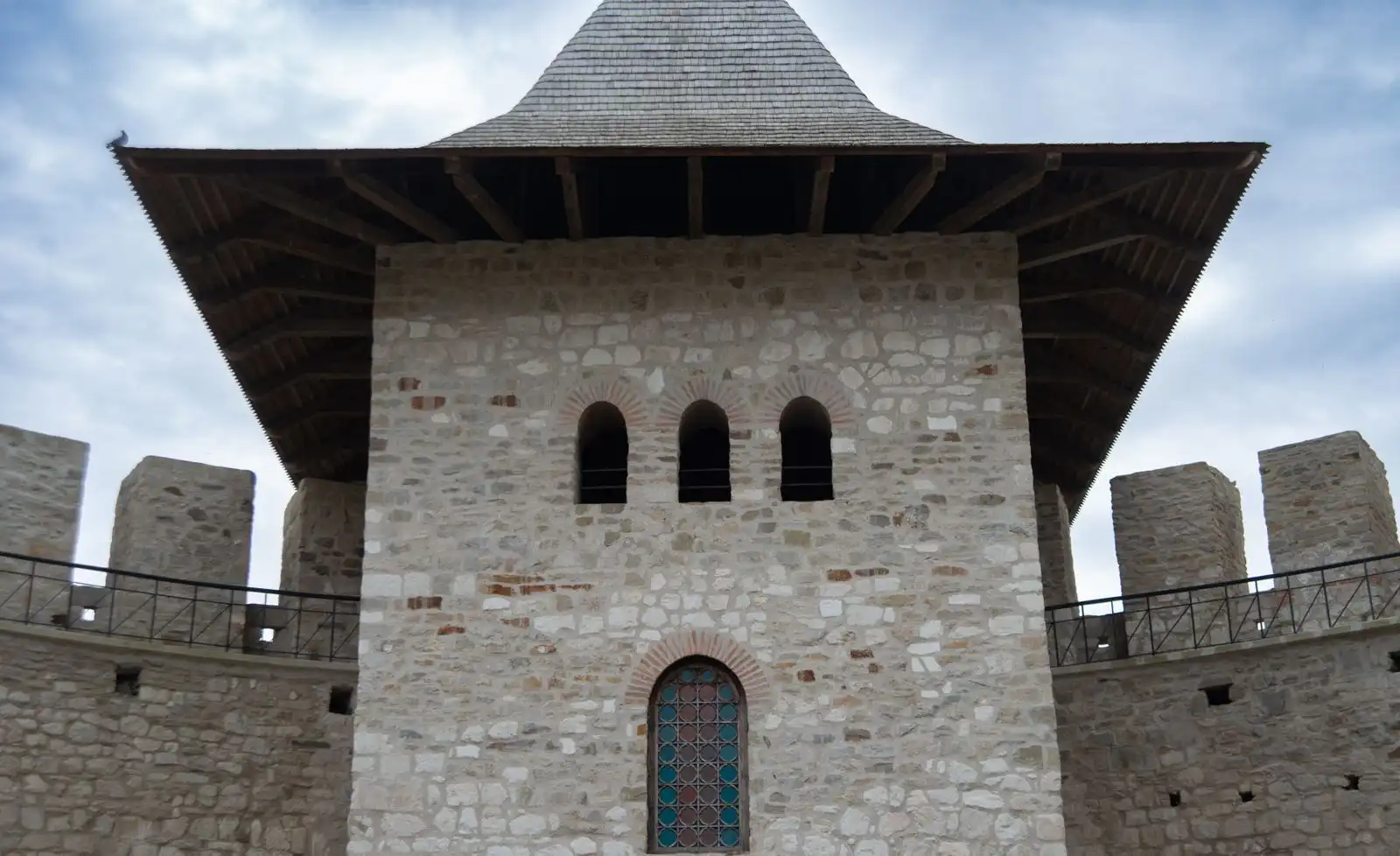 A stone tower of Soroca Fortress with a wooden roof