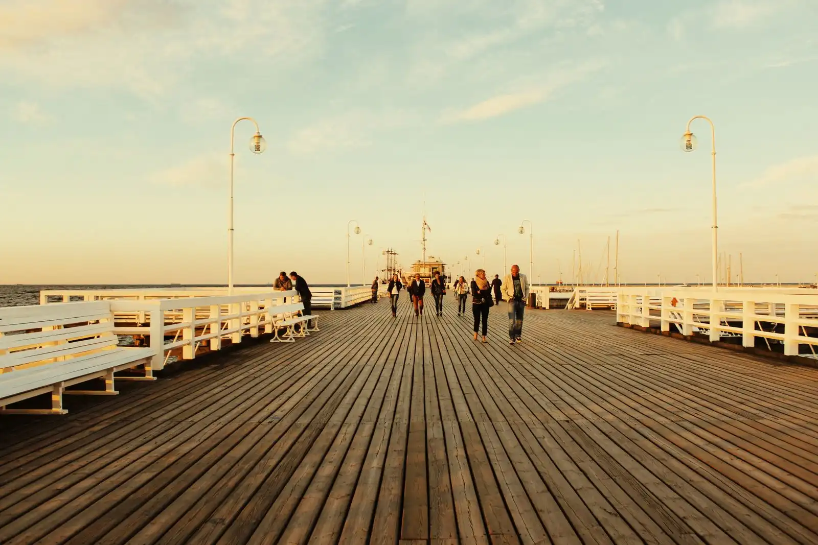 People walking along Sopot Pier in the evening