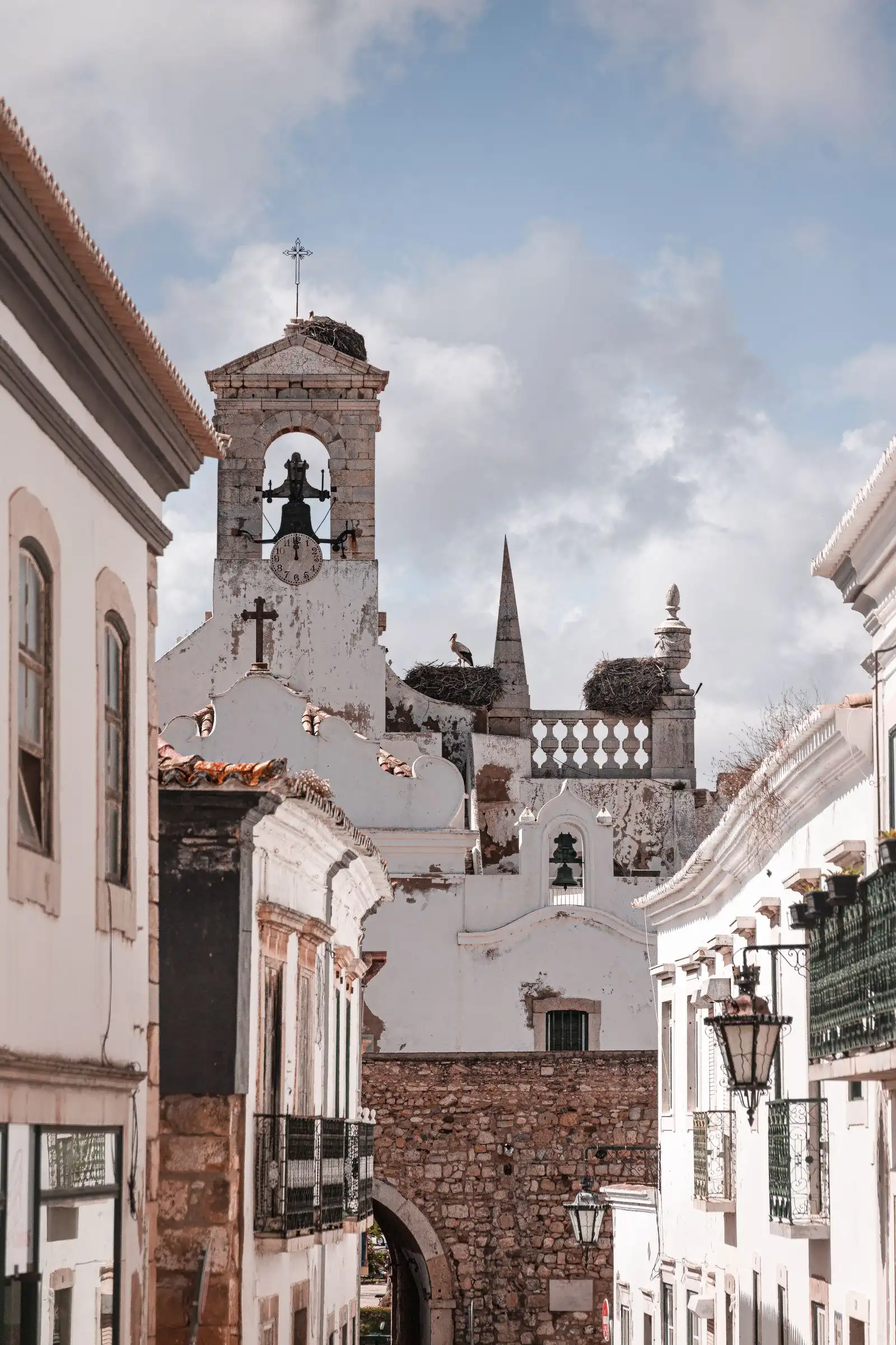 A bell tower and white buildings in Faro's old town