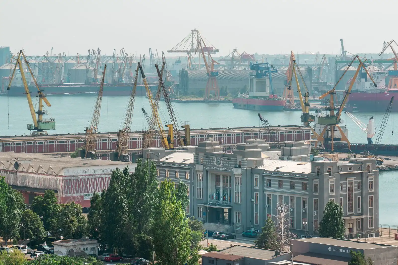 Cranes and ships behind the maritime terminal at Constanța Port