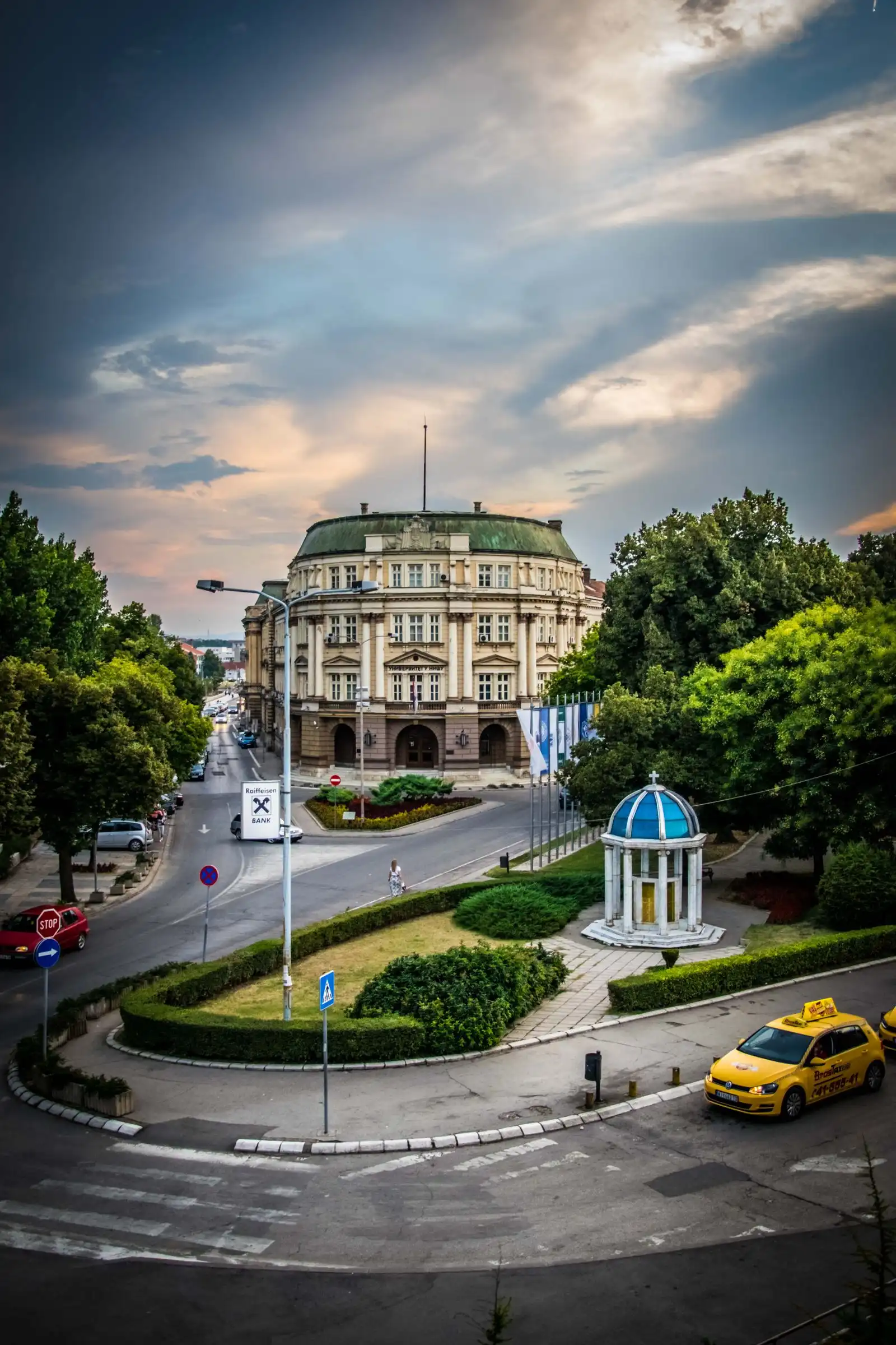The University of Niš building beside a tree-lined street