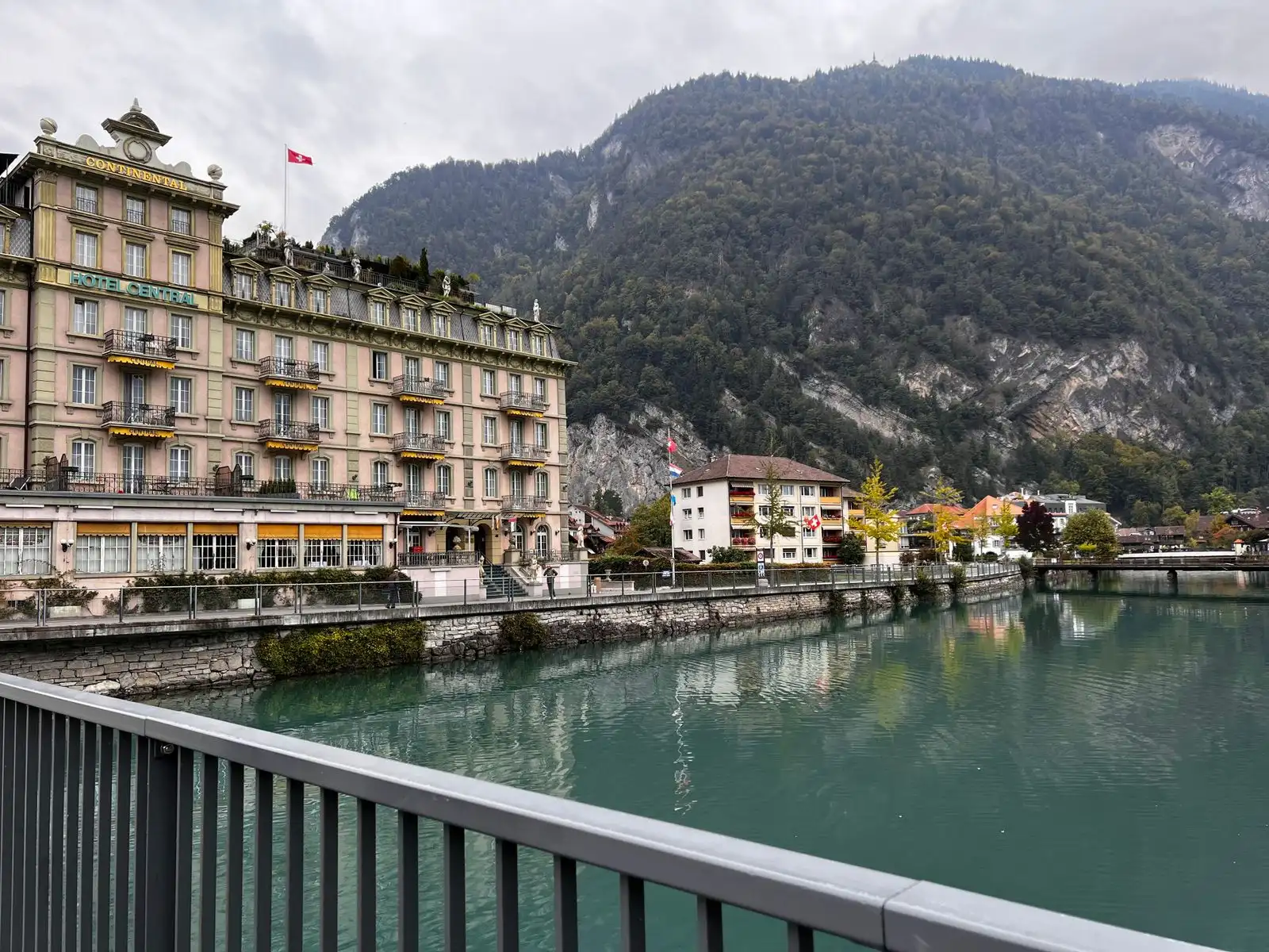 Buildings beside the Aare with wooded hills behind Interlaken
