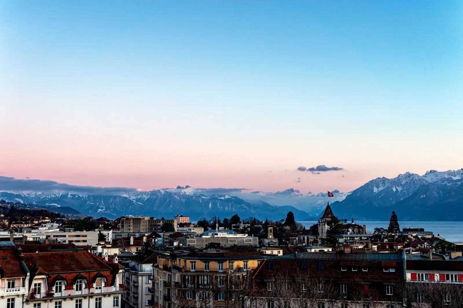 Lausanne's buildings with Lake Geneva and the Alps behind