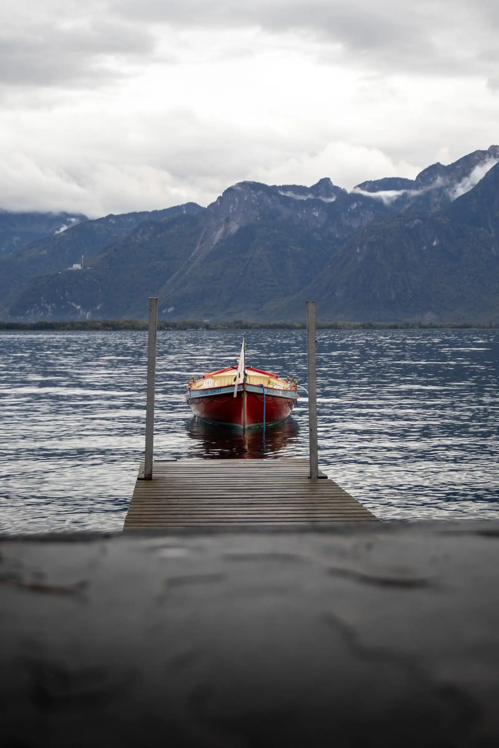 A boat beside a jetty on Lake Geneva in Montreux