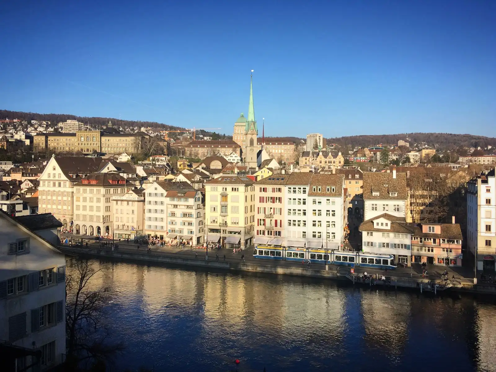 Zurich's historic buildings and church spire beside the Limmat
