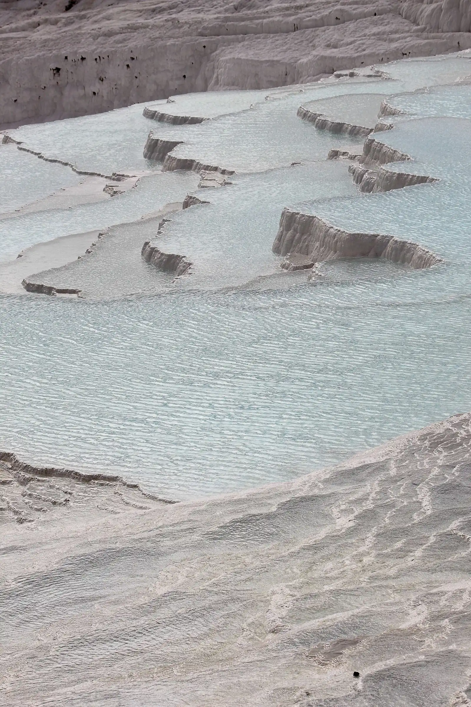 Pale travertine terraces and blue pools at Pamukkale