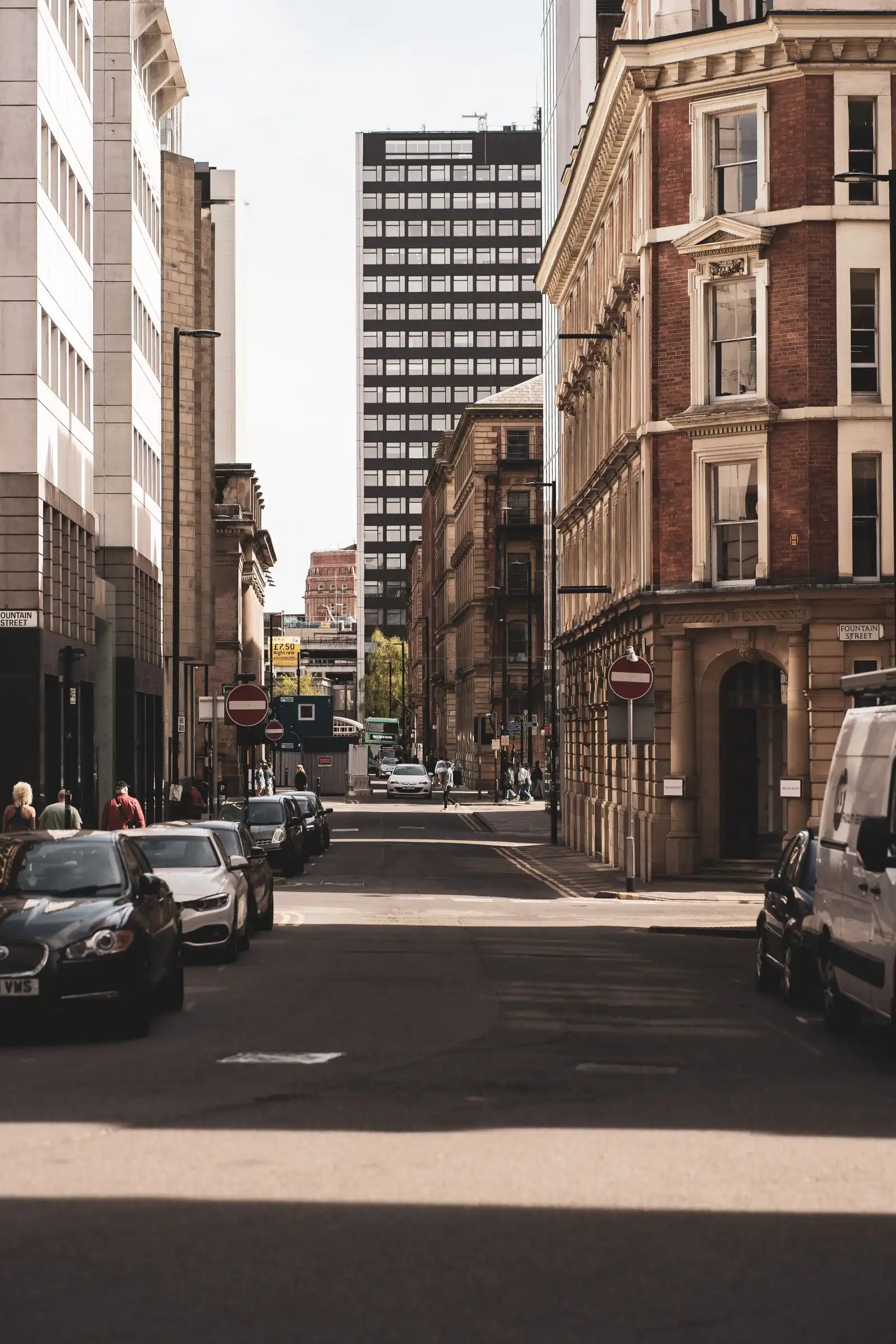 A street lined with brick buildings in Manchester city centre