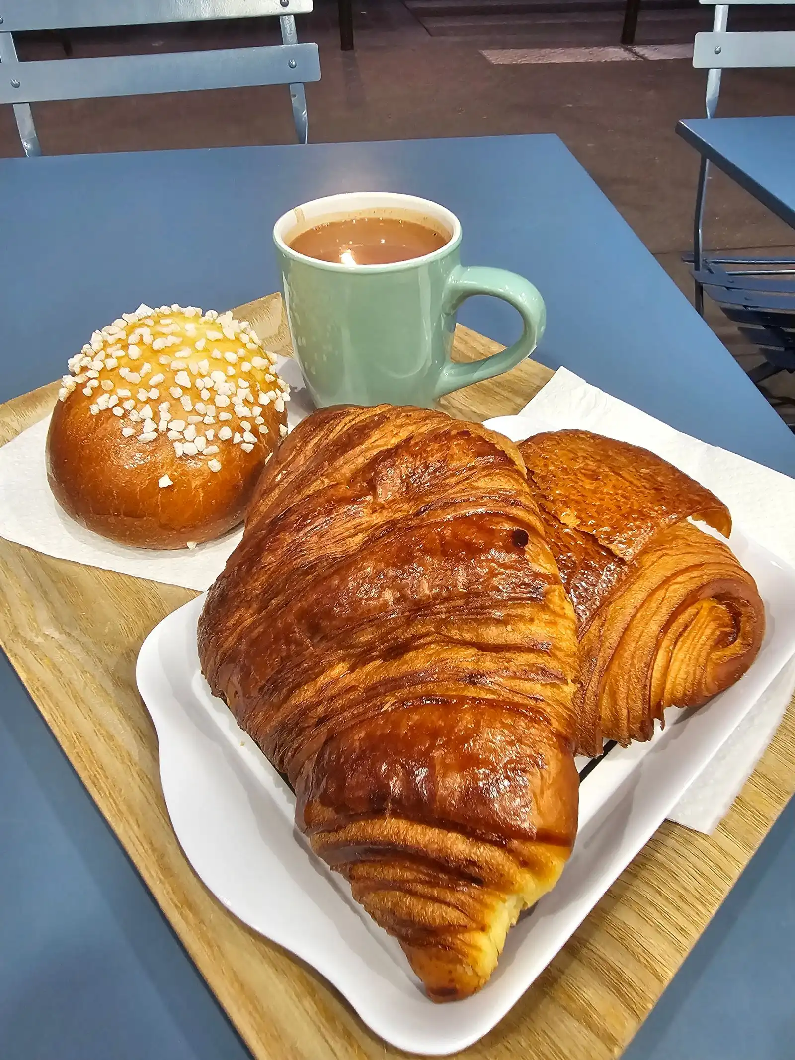 Croissant, pastries and coffee on a café table