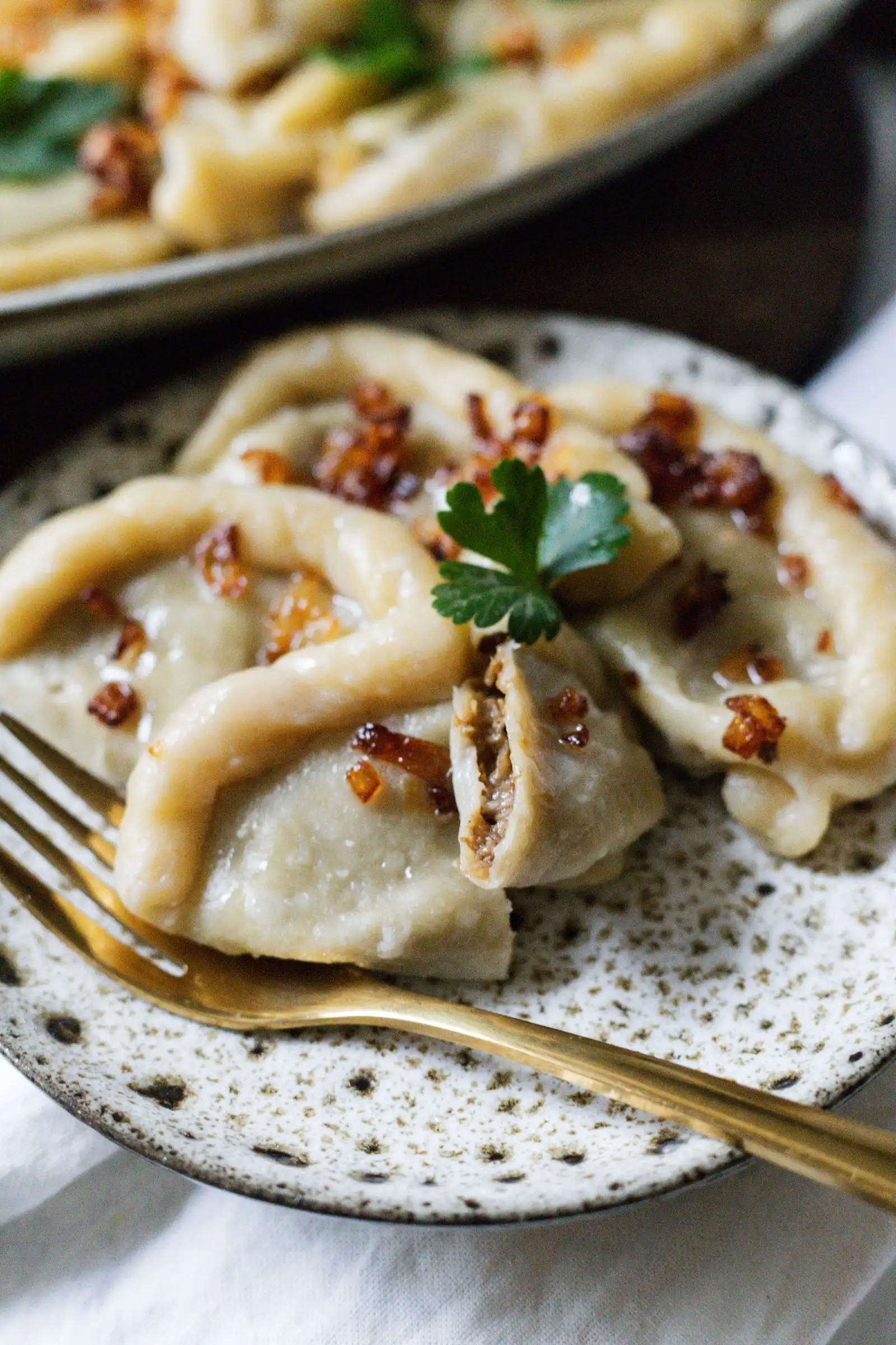 Pierogi topped with fried onions on a plate