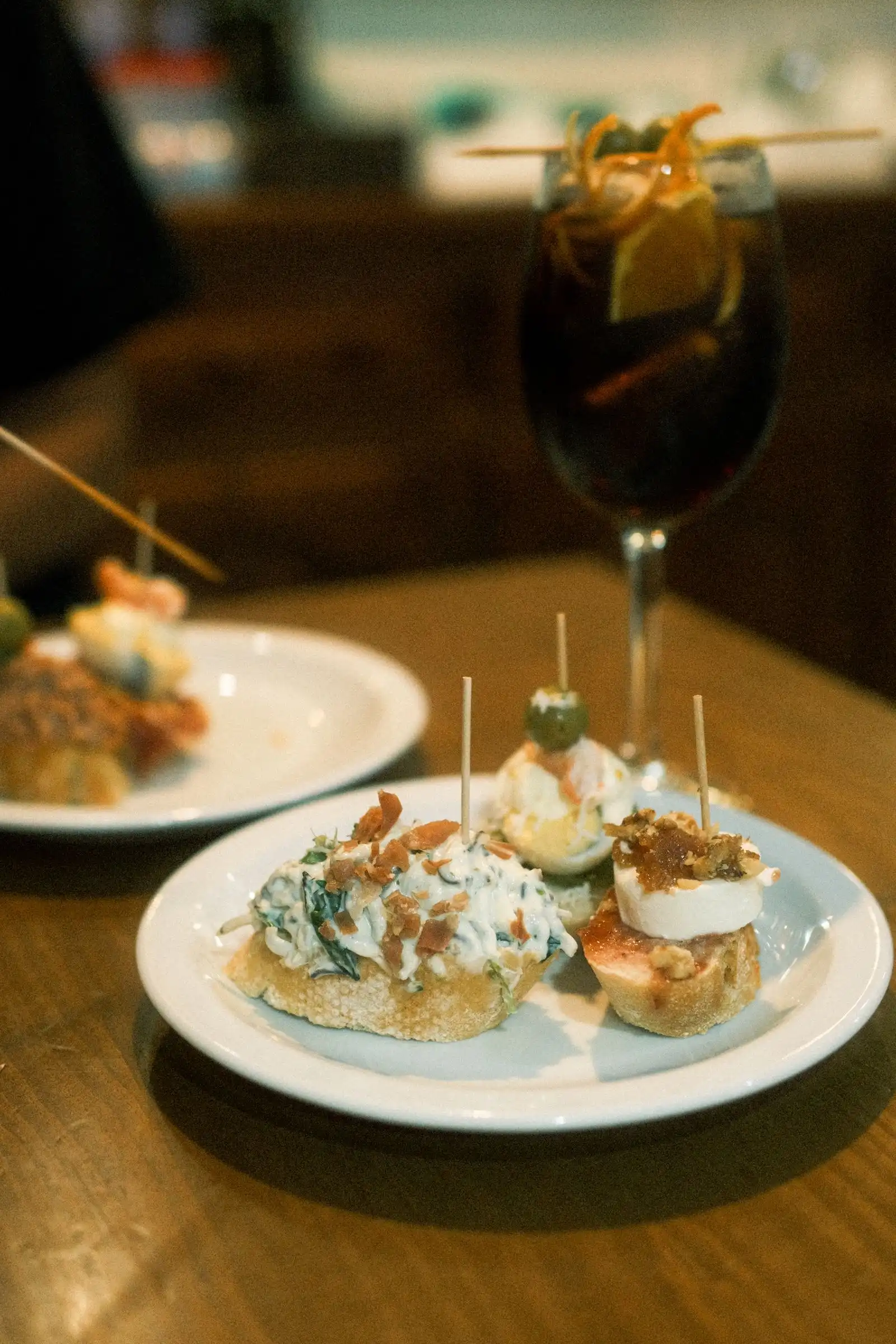 Small plates of tapas with a drink on a restaurant table