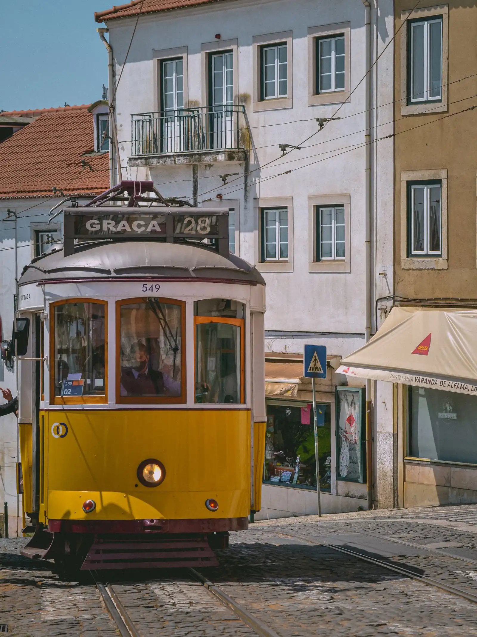 Yellow tram on a street in Lisbon