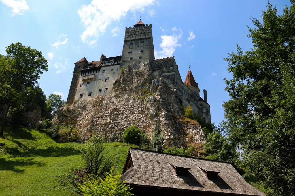 a large castle on top of a hill surrounded by trees